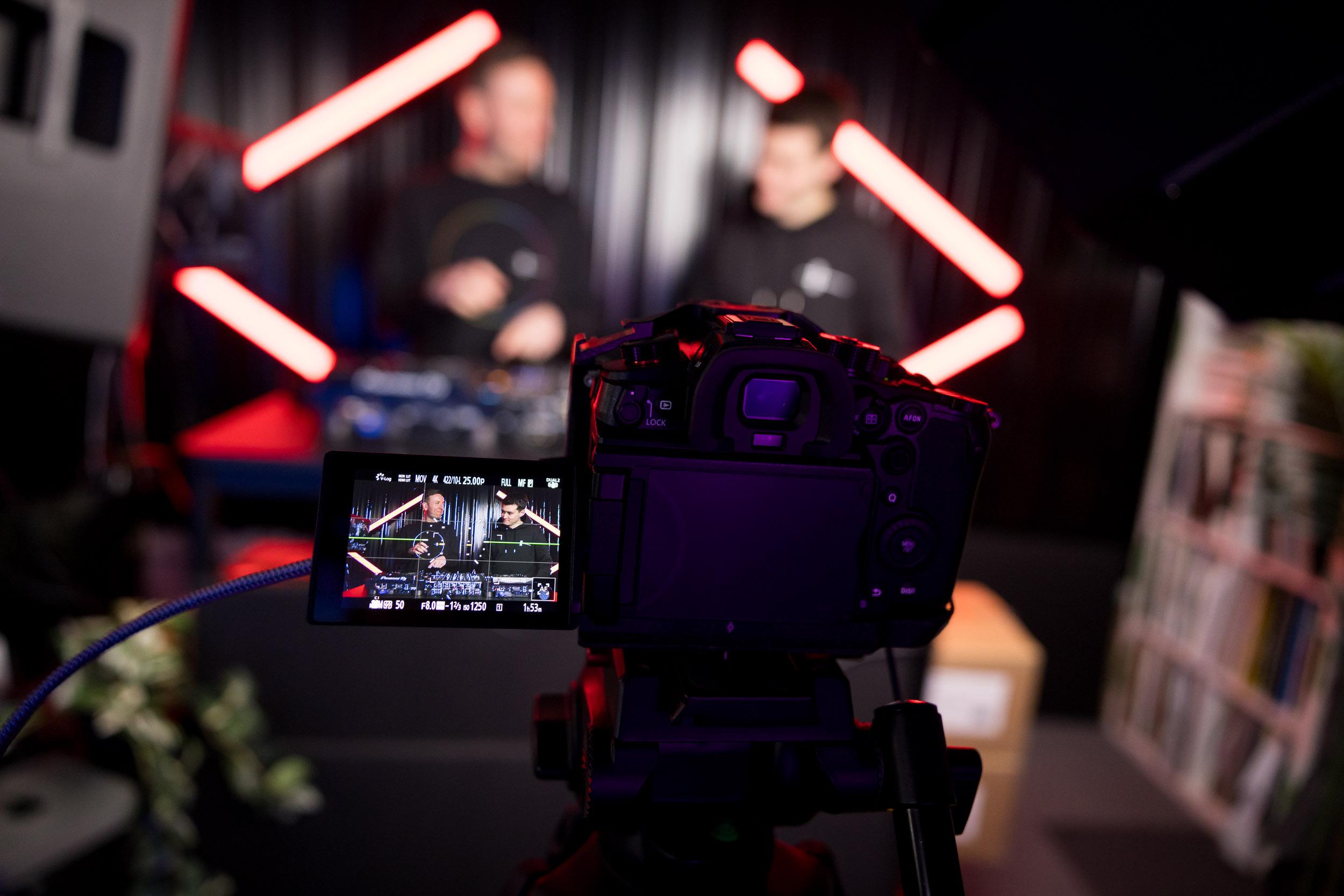 View through a camera viewfinder of a Crossfader lesson being filmed in studio.