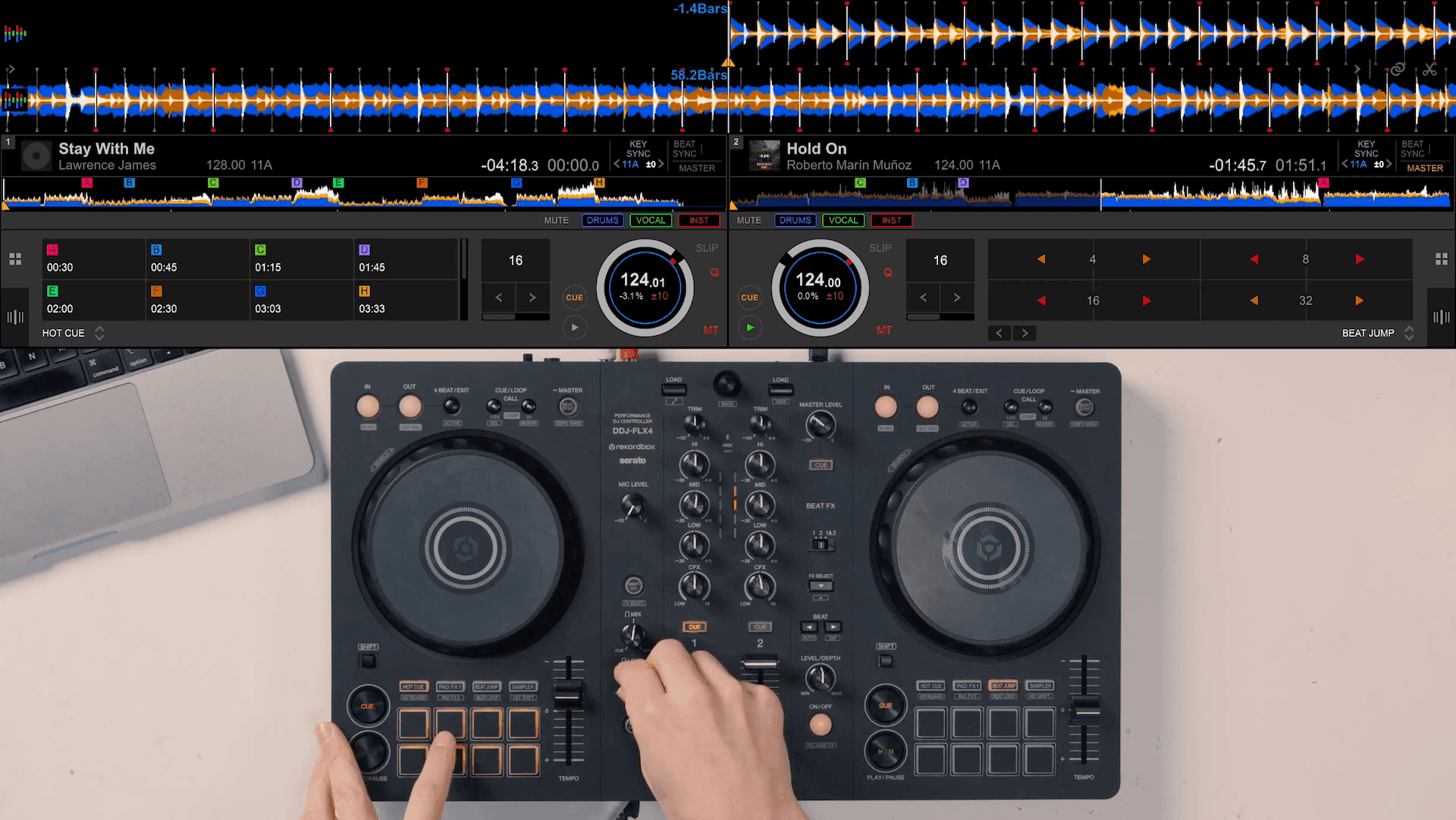 Top-down view of hands mixing on a DDJ-FLX4 controller, with track waveforms on screen above