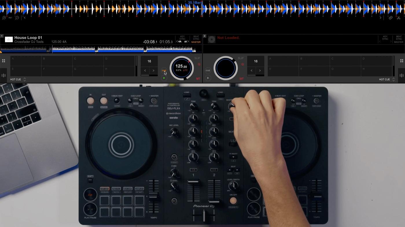 A track loaded in rekordbox with a hand on the FLX4 mixer